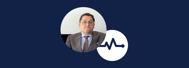 Headshot of Dr Evangelos Giannitsis being interviewed, in front of the black and white Cardio Thinklab logo, against a blue-black backdrop.